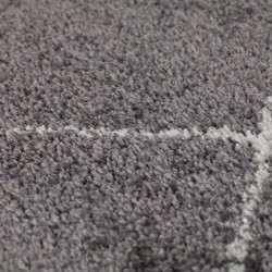 Tapis gris foncé au motif géométrique zigzag ivoire
